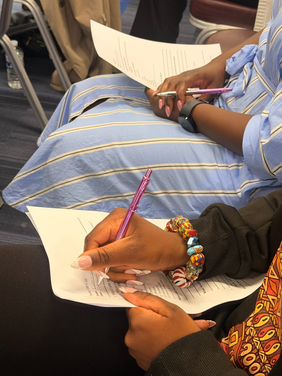 Attendees writing notes during a Dwell 2026 session